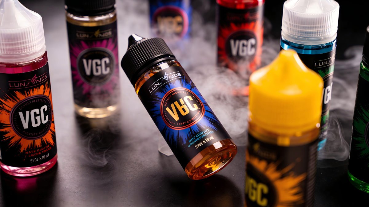 A colorful array of high-VG e-liquid bottles used for cloud chasing.