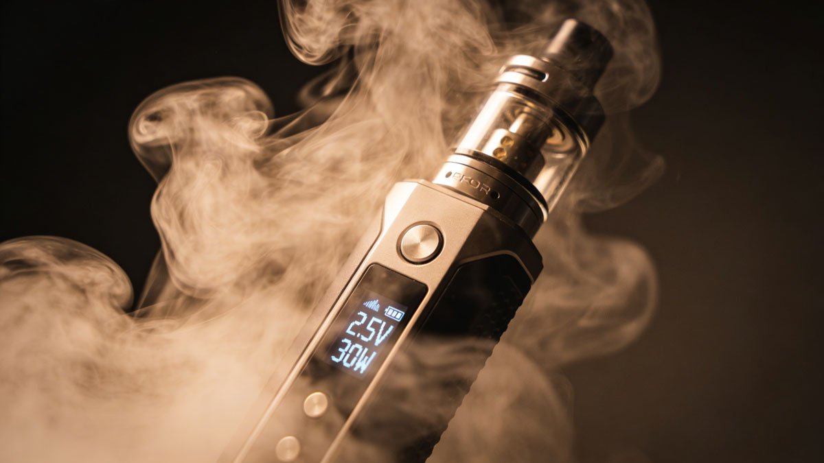 Close up of vapor clouds with a sleek vape device showing digital display